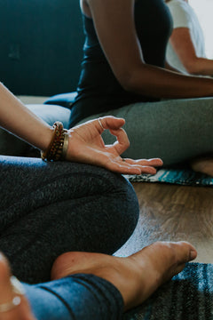 Woman's hand in a mudra during a yoga class.